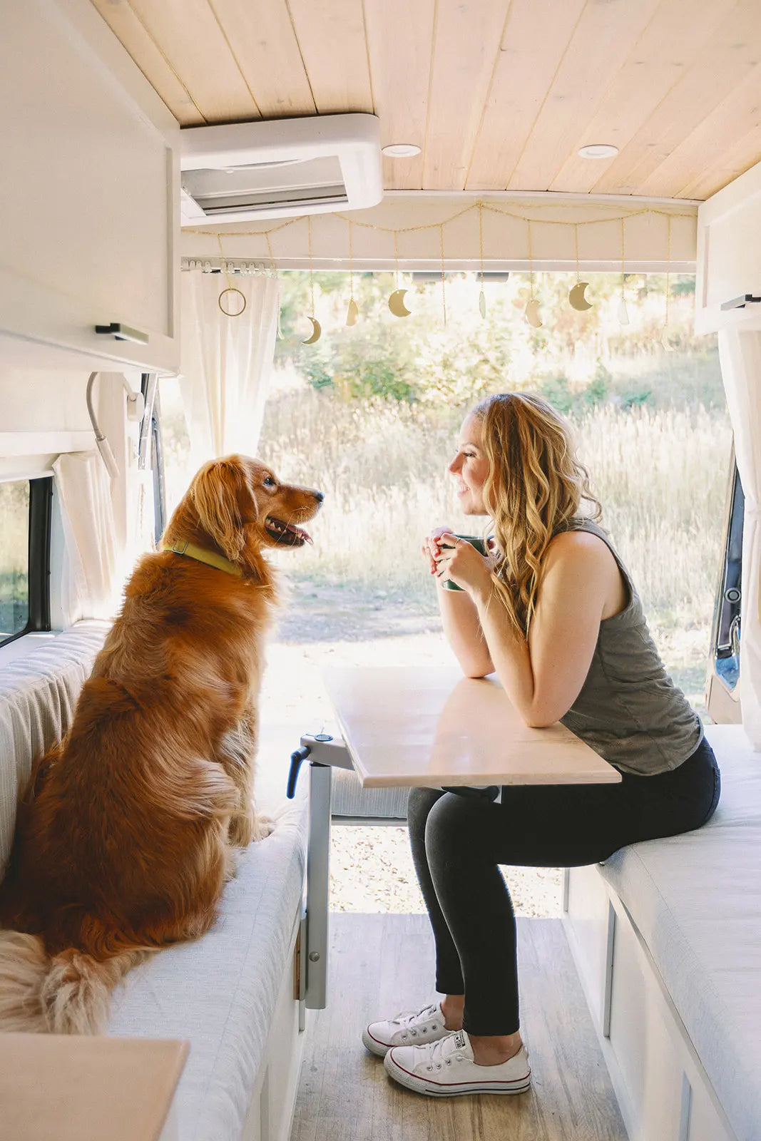Clare Fleming with dog in her campervan.