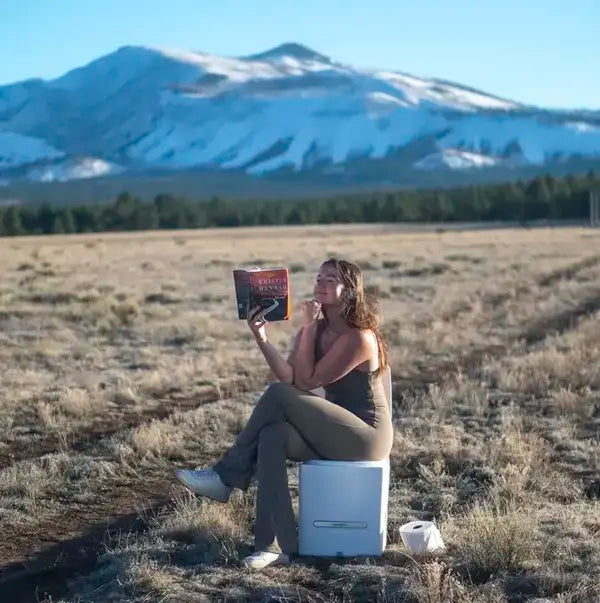 reading-book-on-cuddy-composting-toielt.webp